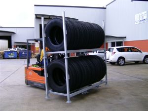 Tyre Racks stacked on top of each other being transported via forklift
